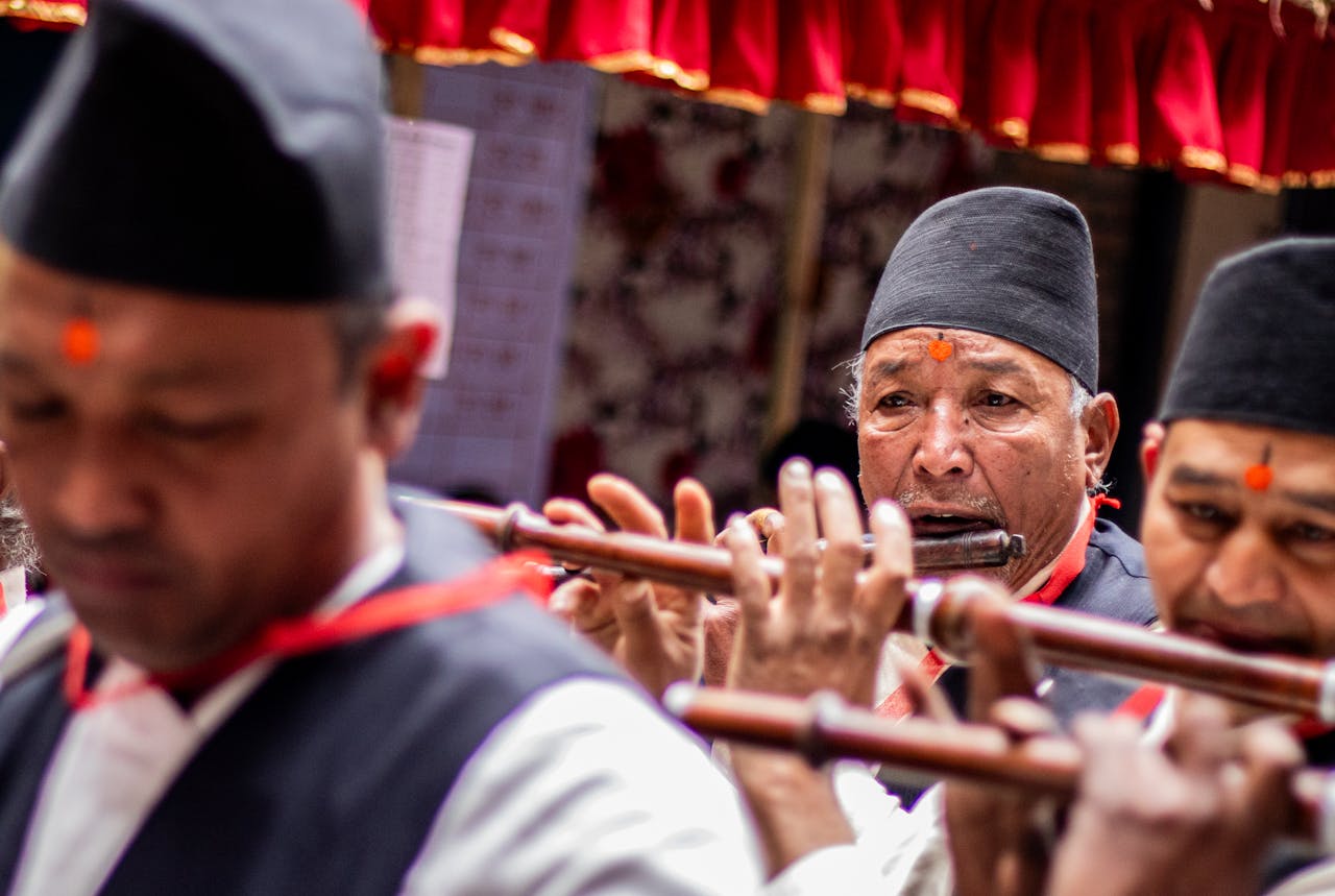 Services A group of traditional musicians playing flutes during a cultural event, wearing traditional attire.